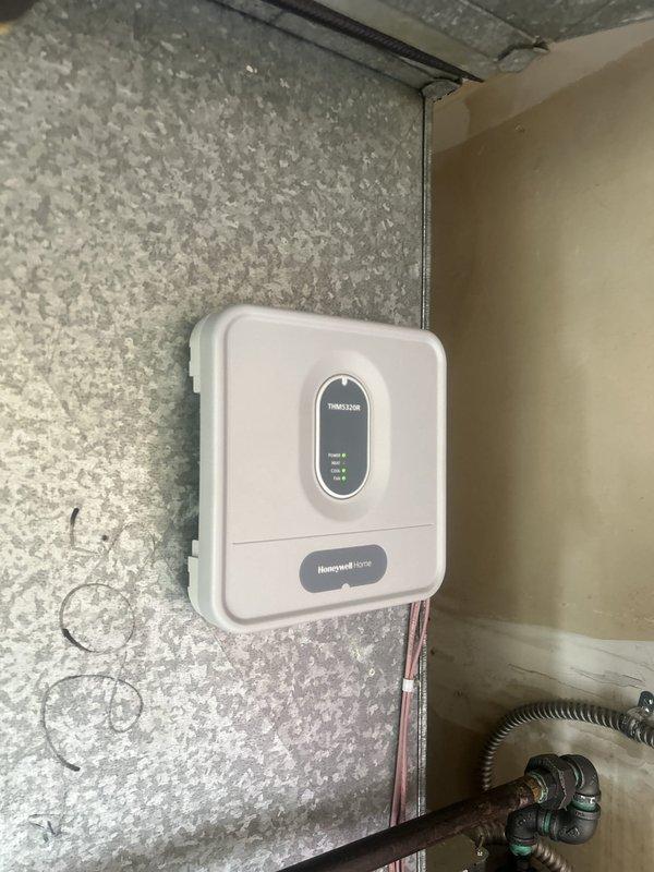 Completed PTAC unit installation with associated mechanical and control systems. Installed Honeywell Home thermostat control with digital display and indicator lights, mounted HVAC cabinet unit with proper ductwork connections including flexible ducting and refrigerant line set with pressure monitoring equipment. All work performed in accordance with state permit requirements, system tested and operational upon completion.