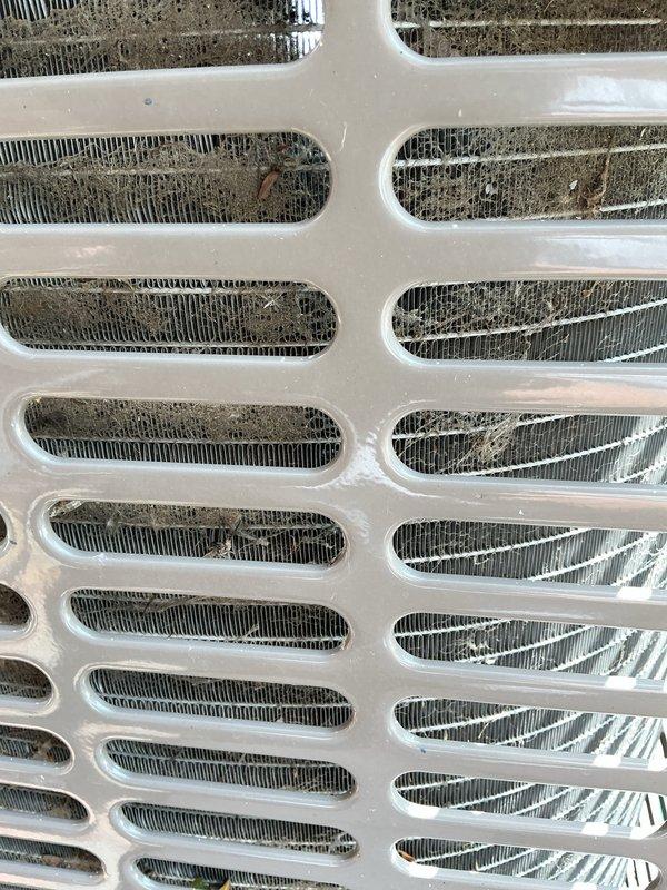 Responded to no cooling complaint on 4-year-old air conditioning system where outdoor unit fan was running but producing no cold air, issue occurring immediately following annual maintenance service. Upon inspection, discovered blower motor failure preventing proper airflow through the evaporator coil. Documented heavily soiled evaporator coil fins with significant dust and debris accumulation visible through access grilles, contributing to reduced system efficiency. Ordered replacement blower motor under purchase order for next-day delivery from supplier. Photographed condition of evaporator coil showing dirt buildup on metallic fins and surrounding components for service records. System requires blower motor replacement to restore cooling function, with recommendation for thorough coil cleaning during motor installation to optimize performance.