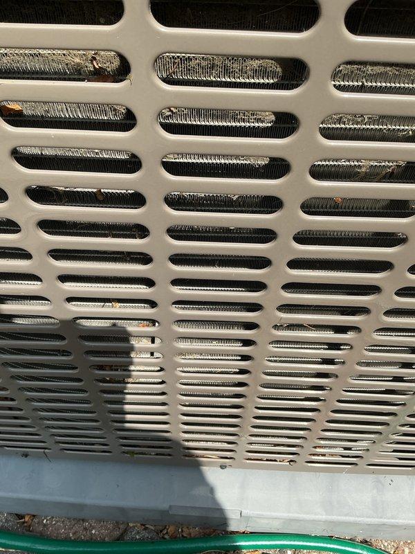 Responded to no cooling complaint on 4-year-old air conditioning system where outdoor unit fan was running but producing no cold air, issue occurring immediately following annual maintenance service. Upon inspection, discovered blower motor failure preventing proper airflow through the evaporator coil. Documented heavily soiled evaporator coil fins with significant dust and debris accumulation visible through access grilles, contributing to reduced system efficiency. Ordered replacement blower motor under purchase order for next-day delivery from supplier. Photographed condition of evaporator coil showing dirt buildup on metallic fins and surrounding components for service records. System requires blower motor replacement to restore cooling function, with recommendation for thorough coil cleaning during motor installation to optimize performance.