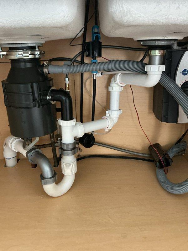 Responded to a clogged double-basin kitchen sink affecting both the garbage disposal side and regular drain side in a 40-year-old home. Performed diagnostic inspection of the drainage system, cleared blockage from the affected drains, and verified proper water flow through both basins and the garbage disposal unit. Tested the complete plumbing assembly including P-traps and connecting pipes to ensure full functionality, with no other drainage issues identified elsewhere in the property.