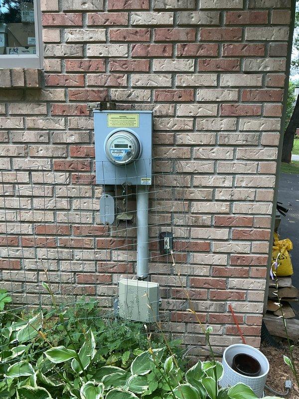 Completed electrical estimate for new whole home generator installation at residential property. Assessed existing natural gas meter and electrical service panel locations on exterior brick wall to determine optimal generator placement and connection points. Documented current utility infrastructure including gas line accessibility and electrical service capacity for proper generator system sizing and installation planning.
