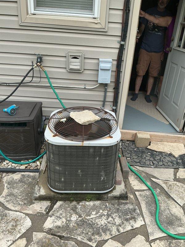 Provided comprehensive replacement estimate for existing 10+ year old natural gas furnace and air conditioning system currently located in utility room. Evaluated outdoor condensing unit positioned on stone patio adjacent to home and assessed indoor air handler with vertical ductwork and insulation configuration. Presented equipment options and system specifications to replace aging HVAC system with modern high-efficiency heating and cooling equipment.