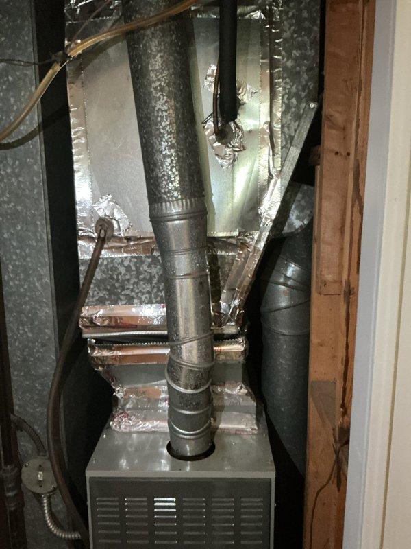 Provided comprehensive replacement estimate for existing 10+ year old natural gas furnace and air conditioning system currently located in utility room. Evaluated outdoor condensing unit positioned on stone patio adjacent to home and assessed indoor air handler with vertical ductwork and insulation configuration. Presented equipment options and system specifications to replace aging HVAC system with modern high-efficiency heating and cooling equipment.