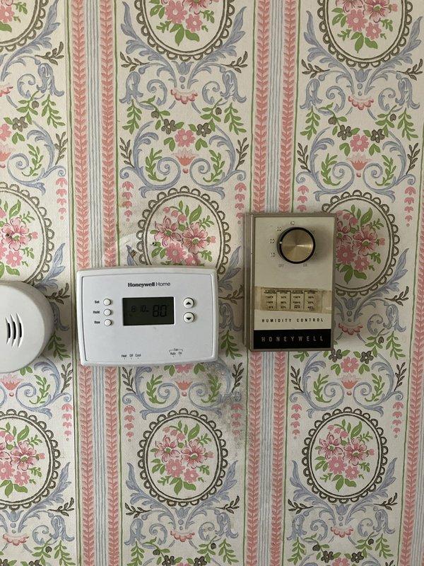 Provided estimate for replacement of existing 1969 furnace and air conditioning system currently located in basement utility area. Existing natural gas furnace and AC unit are operational but nearing end of service life at over 50 years old. Assessed current equipment configuration including ductwork, humidifier control system, and thermostat setup to provide comprehensive replacement options for modern high-efficiency HVAC system.