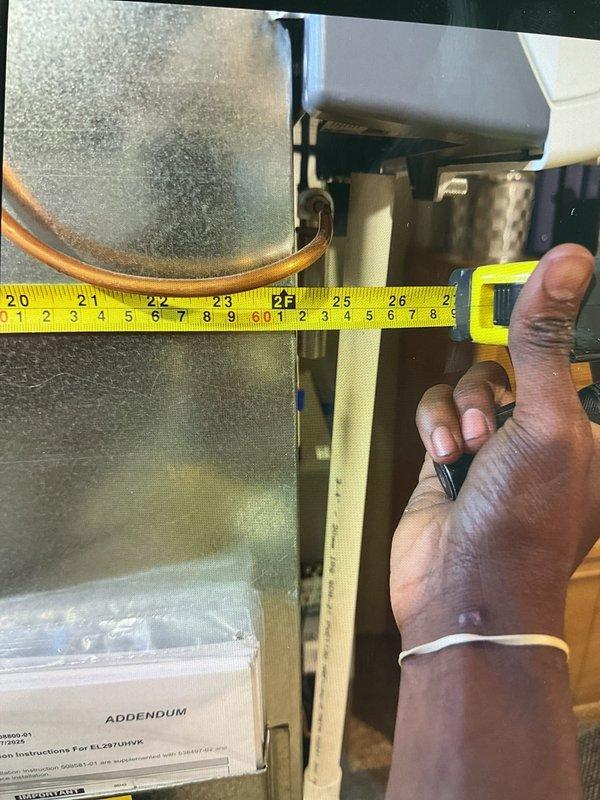 Responded to customer complaint of loud boom noise occurring when air conditioning system shuts off. Inspected 1-year-old AC system and associated furnace/air handler unit located in basement. Upon examination, identified potential issue with ductwork expansion/contraction or damper operation causing audible noise during system shutdown. Performed visual inspection of heat exchanger, blower assembly, and cabinet interior. Documented equipment dimensions and current operational status with digital temperature readings showing 50°F at evaporator coil. Verified proper airflow through filter media and assessed metallic components for secure mounting. Advised homeowner on findings and recommended monitoring system performance through remainder of cooling season.