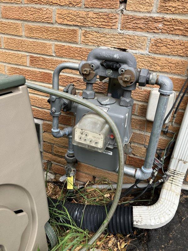 Completed electrical estimate for new whole home generator installation at manufactured home. Assessed existing natural gas meter location on exterior brick wall and evaluated current electrical panel capacity and available space in utility room for generator transfer switch integration. Documented gas supply routing and electrical service configuration to determine optimal generator placement and connection requirements.