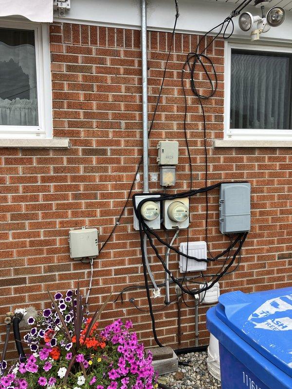 Conducted comprehensive site assessment for whole home generator installation at residential brick structure. Evaluated existing electrical infrastructure including dual meter configuration, conduit routing, and junction box placement on exterior wall to determine optimal integration point for generator system. Documented current electrical service capacity and identified suitable location for generator placement considering clearance requirements, fuel line access, and proximity to existing electrical panels for efficient transfer switch installation.