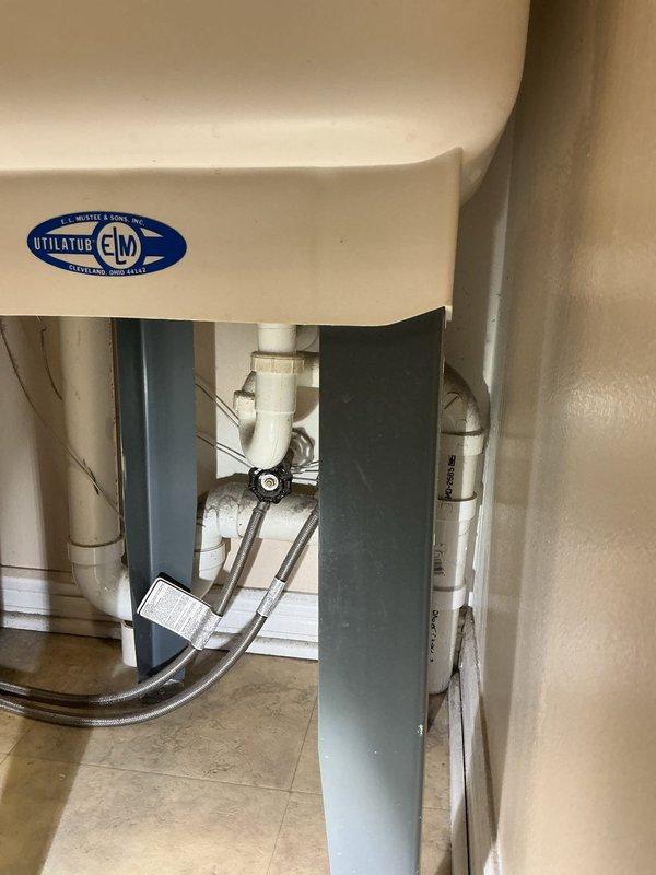 Responded to service call for utility tub emitting gassy odor in basement area. Upon inspection, identified issue with drain trap system beneath UTILATUB fixture. Customer had been using temporary tablet treatments which were no longer effective as condition worsened. Examined PVC drain assembly and connections under utility sink, checking for proper trap configuration and venting issues that could allow sewer gases to escape into living space. Assessed plumbing connections, flexible supply lines, and drain piping for potential dry trap, partial blockage, or venting deficiency causing odor penetration. Documented existing conditions of utility room plumbing system including water heater proximity and drain line configuration for service records.