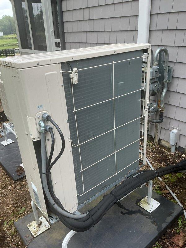 Completed comprehensive Gold AC inspection on residential property equipped with two central air conditioning systems and two mini-split units, all installed in 2022. Performed thorough evaluation of outdoor condenser units, including visual inspection of Lennox equipment cabinets, cooling coils, refrigerant line connections, electrical disconnects, and mounting hardware. Verified proper operation of all systems, examined condenser fan assemblies, checked refrigerant line integrity and mounting brackets, and assessed overall equipment condition. Inspected concrete pads for stability and levelness, confirmed electrical connections and junction boxes were secure, and evaluated exterior installation components including conduit routing and wall penetrations. All four HVAC systems were found to be in functional condition with normal weathering appropriate for outdoor installations. Equipment showed proper maintenance and installation standards with secure mounting hardware and utility conn