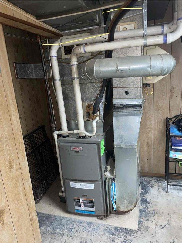 Responded to service call for Lennox furnace experiencing short-cycling issues (running approximately 10 minutes before shutting down) and Lennox central air conditioning system not producing cold air. Performed comprehensive system evaluation of both heating and cooling equipment. Inspected basement-installed furnace unit with PVC venting system and assessed approximately 20-year-old outdoor condensing unit. Documented existing equipment conditions through photographic documentation of furnace installation, ductwork configuration, and thermostat location. Based on equipment age, performance issues, and previous unsuccessful repair attempts, provided estimate for complete HVAC system replacement. Discussed financing options available for new equipment installation.