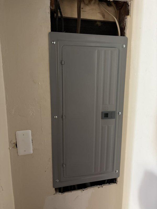 Completed 150 amp electrical service upgrade for residential property. Installed new main electrical panel on interior wall with proper circuit breaker distribution box and secure mounting. Ran new service entrance conductors from exterior meter base through gray PVC conduit system down exterior wall, properly secured with mounting brackets. Upgraded meter base and established new service connection point. Installed exterior junction boxes and weatherproof enclosures to code specifications. Routed all electrical conduits along exterior siding and through foundation penetration to connect with new interior panel. All work performed in compliance with current NEC standards for residential service upgrades. System tested and verified operational upon completion.