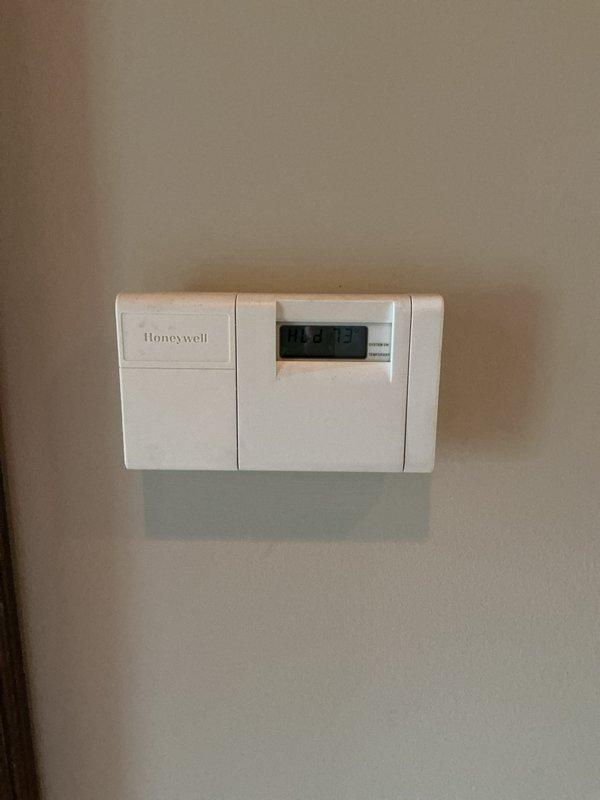 Completed air conditioning inspection on two AC units located in basement. Assessed existing equipment condition, age, and operational status to provide comprehensive full system replacement estimates for both units. Documented current thermostat configuration and system controls as part of evaluation process.