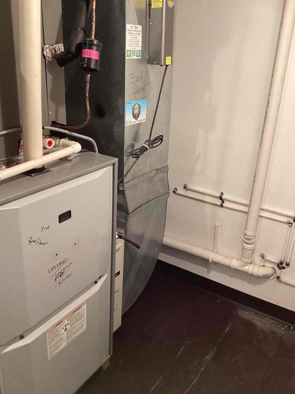 Provided comprehensive estimate for complete HVAC system replacement at lower level location, evaluating 20-year-old air conditioning condenser unit and furnace system that have reached end of serviceable life. Assessed outdoor AC unit mounted on concrete pad against brick exterior wall near electrical meters and indoor furnace equipment in mechanical room, documenting existing installation configurations, electrical connections, and spatial requirements for new equipment. Presented replacement options and specifications for modern high-efficiency heating and cooling systems to restore reliable climate control to the residence.