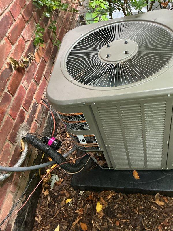 Completed comprehensive Gold Plan preventive maintenance on three 7-8 year old air conditioning systems including one garage unit, one exterior ground-level unit, and one rooftop unit requiring ladder access. Performed full system inspections on all three condensing units including visual examination of cabinet conditions, refrigerant line insulation integrity, electrical connections, and component wear. Verified proper operation of condenser fan motors, checked compressor functionality, and confirmed adequate airflow through coil assemblies. Inspected condensate drainage systems and PVC discharge lines for proper flow and blockages. All three systems operating within normal parameters with no deficiencies noted. Units showed typical weathering consistent with outdoor exposure and age but remain in serviceable condition. Refrigerant lines properly insulated with appropriate line set protection observed on exterior units. All safety labels and manufacturer specifications visible and int