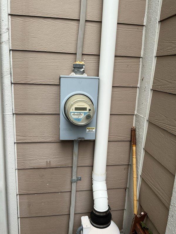 Conducted site evaluation for whole-house generator installation at residential property. Documented existing electrical infrastructure including main service panel with dual-column circuit breaker configuration and exterior utility meter with associated conduit and PVC service entrance. Customer declined to proceed with Generac generator system after assessment was completed.