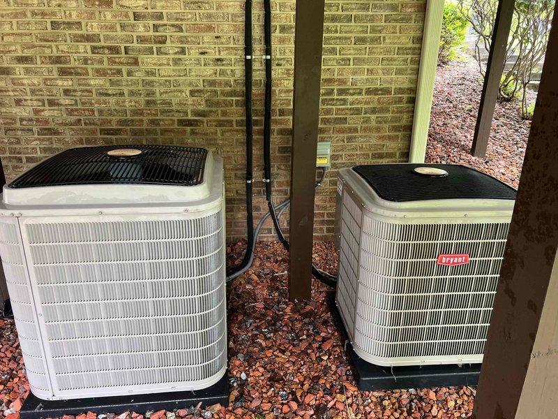 Completed Gold AC Inspection on two outdoor Bryant air conditioning units located on exterior mulch bed. Performed comprehensive system evaluation including visual inspection of condenser units, coils, electrical connections, and associated equipment in basement mechanical room. Both units showed proper installation with intact protective grilles, clean exteriors, and professional conduit routing; all systems operational with no immediate service needs identified.