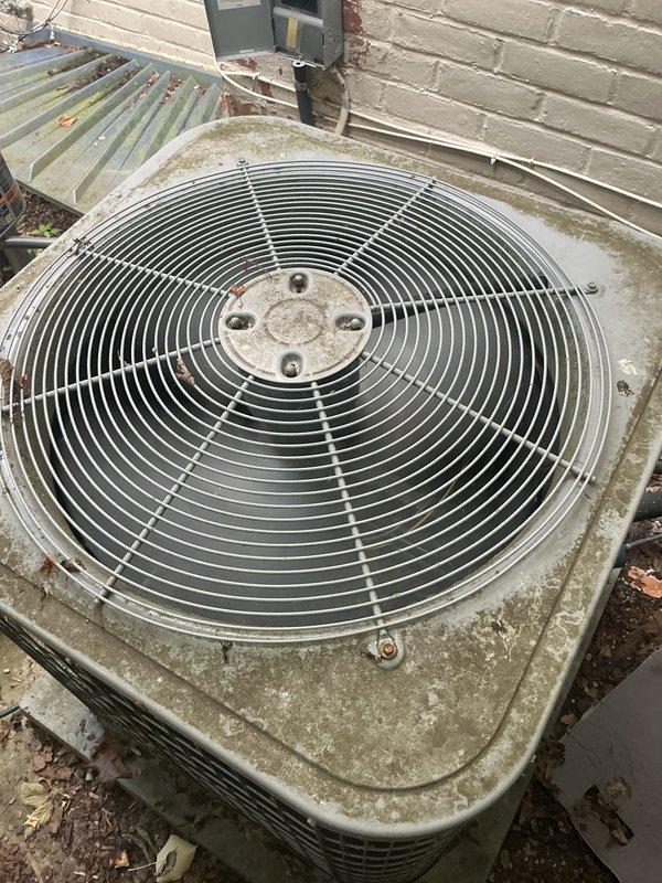 Completed comprehensive Gold AC Inspection on a 10-year-old Lennox air conditioning system with outdoor condensing unit located in basement area. Performed thorough examination of condensing unit, noting significant weathering, dirt accumulation, and organic growth on exterior casing and components. Inspected fan assembly with protective wire guard, verified electrical disconnect box mounting and connections, examined refrigerant line connections, and assessed overall unit operation. Documented unit condition showing age-related wear consistent with outdoor exposure, including surface deterioration and debris accumulation around base. All major components inspected and system operational status verified per Gold maintenance protocol specifications.