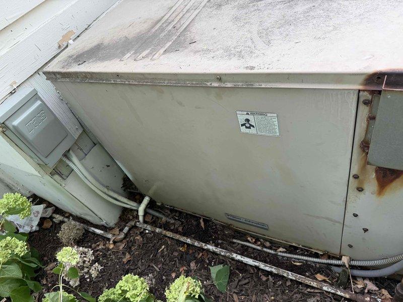 Responded to no cooling complaint with no air flow from vents. Upon arrival, found outdoor condensing unit in severely deteriorated condition with extensive rust damage on cabinet panels and internal components. Unit interior contained heavy accumulation of leaves, dirt, and organic debris surrounding electrical components including capacitor and wiring connections. Exterior cabinet showed significant corrosion along edges and panels with weathering from prolonged exposure to elements. Removed debris from unit interior and assessed electrical connections. Due to extensive rust damage compromising structural integrity and potential electrical hazards from moisture infiltration around capacitor and wiring, recommended unit replacement rather than repair given safety concerns and deteriorated condition of components.
