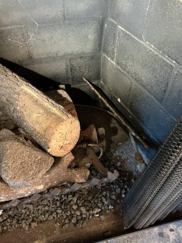 Responded to service call regarding strange noises coming from gas fireplace when flame is activated. Performed comprehensive inspection of gas line routing from main supply to fireplace unit. Examined corroded gas piping and valve assembly at basement connection point, noting significant age-related deterioration of metal components and fittings. Inspected fireplace unit interior compartment and burner assembly, identifying accumulated debris and degraded insulation material within firebox. Conducted pressure testing and leak detection on gas line connections. Documented existing conditions of aged infrastructure with photographic evidence for homeowner records.