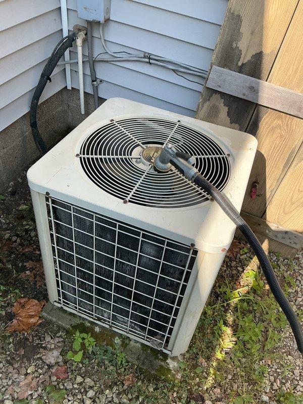 Completed comprehensive tune-up and inspection on 20+ year old furnace and air conditioning system. Inspected gas valve assembly, electrical connections, and control components in furnace located in utility room; verified proper operation and connections of all wiring harnesses. Performed exterior condenser unit inspection, checking fan operation, refrigerant lines, electrical conduit connections, and ensuring adequate clearance around unit mounted on concrete pad.