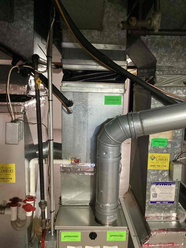 Completed annual air conditioner maintenance on outdoor unit of unknown age. Performed comprehensive AC tune-up including system inspection, cleaning, and operational testing. Equipment found to be in functional condition with no immediate repairs required. Indoor HVAC components including furnace and ductwork were documented during the service visit, showing approved installation with proper connections and labeling. System is operational and ready for continued service.