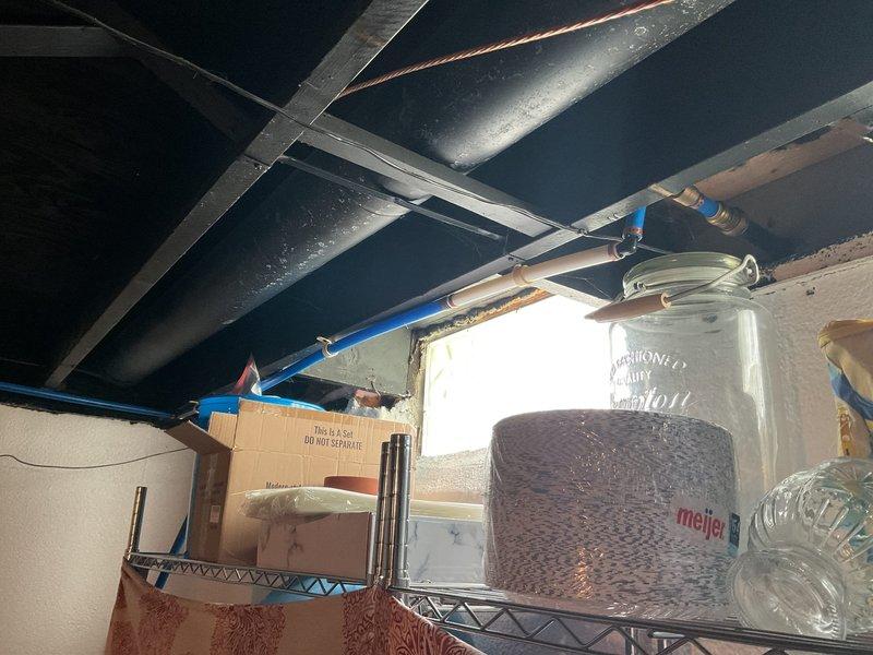 Conducted site assessment for installation of second water meter at residential property. Evaluated existing plumbing infrastructure in basement area, including current water service entry point, copper supply lines, and available space for additional metering equipment. Documented existing conditions through photographs showing ceiling-mounted piping, water heater connections, and structural layout to determine optimal routing and installation location for secondary meter assembly.