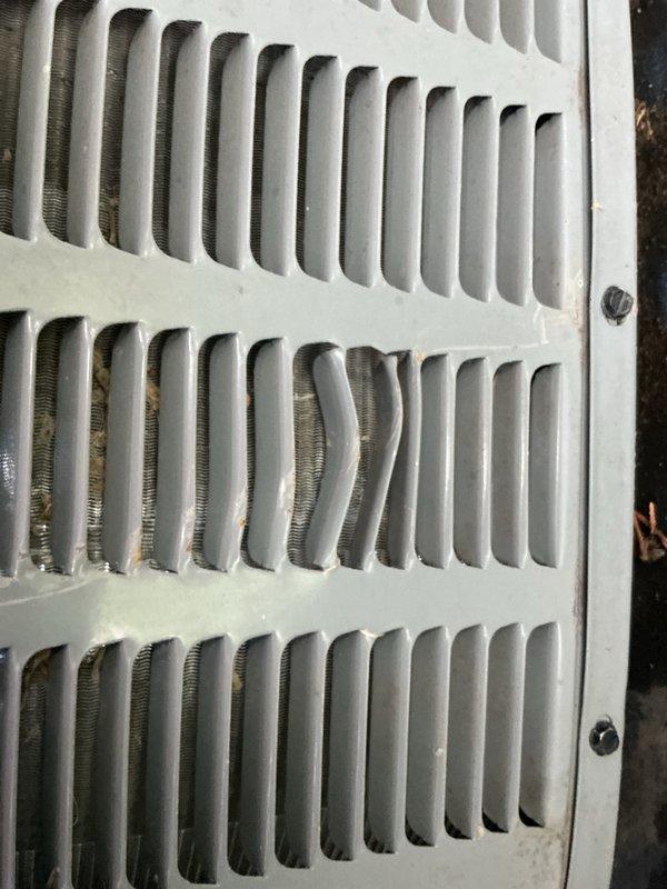 Completed comprehensive tune-up and inspection of 2018 AC system located in basement. Inspected exterior disconnect box, verified proper electrical connections and confirmed operational status. Checked ventilation register and ductwork connections, documented equipment condition with photos showing normal wear consistent with age.