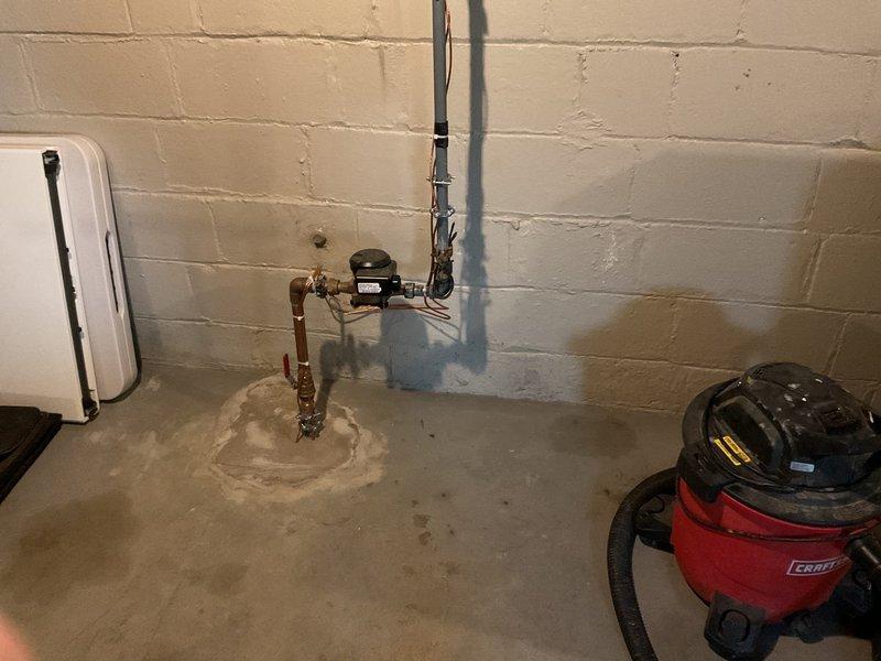 Provided quote for installation of utility sink and washer/dryer hookups in basement laundry area. Assessed existing plumbing infrastructure including copper supply lines, water meter assembly, and drainage system. Evaluated space requirements and utility connections needed for proposed utility sink installation adjacent to existing laundry appliances.