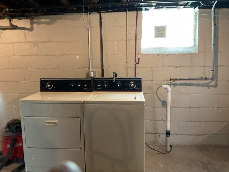 Provided quote for installation of utility sink and washer/dryer hookups in basement laundry area. Assessed existing plumbing infrastructure including copper supply lines, water meter assembly, and drainage system. Evaluated space requirements and utility connections needed for proposed utility sink installation adjacent to existing laundry appliances.