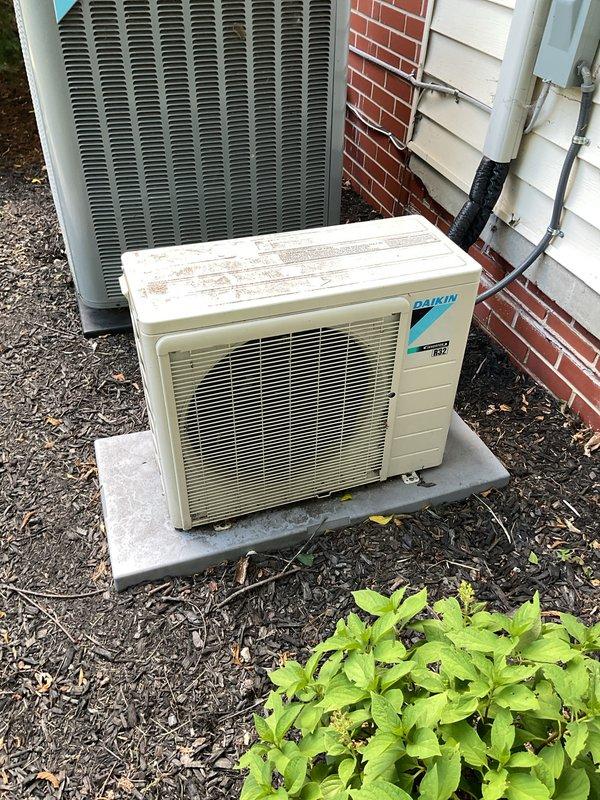 Completed comprehensive Gold AC inspection on Daikin mini-split system with outdoor condensing unit and basement-located air handler. Performed full system evaluation including visual inspection of condenser unit showing normal wear for 3-5 year old equipment, verified operational status of all components, checked refrigerant lines and electrical connections, and documented equipment condition with photographic records. All systems found operating within normal parameters at time of inspection.