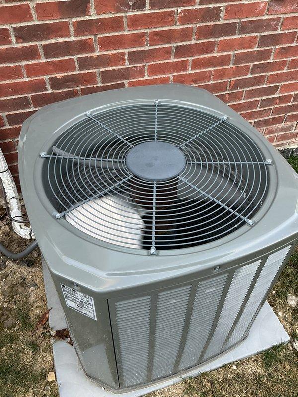 Completed comprehensive Gold AC Inspection on a 6-year-old Trane XR system (Model: 4TTR3036H1000NA, manufactured 11/2019) with 410A refrigerant. Performed full seasonal tune-up including inspection of condenser unit mounted on concrete pad, verified electrical specifications (208/230V, 18.0 amps), checked compressor and condenser motor operation, inspected fan assembly and protective grille, confirmed proper airflow through louvered panels, and examined refrigerant lines and drainage. Unit operating within manufacturer specifications with no deficiencies noted; system ready for cooling season.