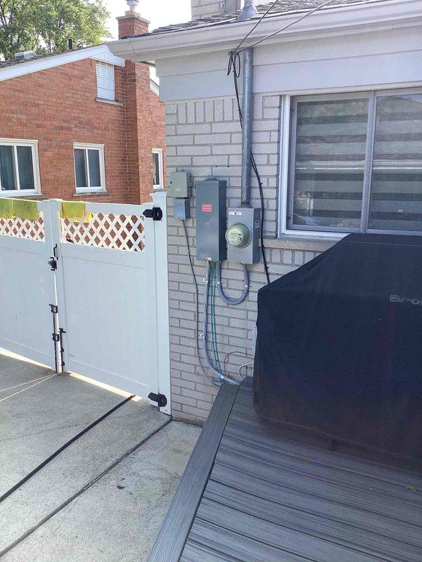 Conducted on-site evaluation for residential air conditioning system replacement. Assessed existing outdoor condensing unit located on rear deck area with electrical service and conduit installation. Documented current Honeywell digital thermostat displaying operational status and humidity readings. Based on property size and cooling requirements, determined appropriate replacement unit sizing in the 2 to 2.5 ton capacity range. Photographed equipment location, electrical connections, and existing HVAC controls for replacement planning and proposal development.