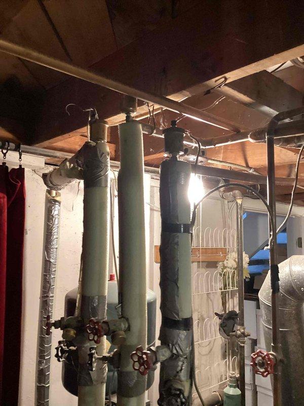 Conducted assessment of aging boiler system located in basement with multiple zone piping configuration. Evaluated existing heating system previously serviced in spring, documented current condition of boiler unit and associated distribution piping with red-handled zone valves. Provided replacement estimate for standard gas-fired boiler per customer preference, excluding electric boiler options as requested.