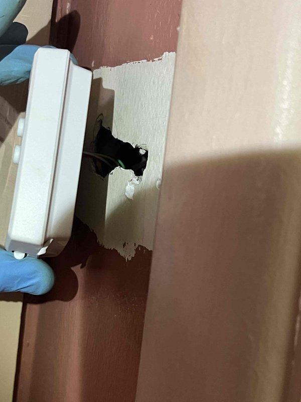 # No Heat Service Call - 10-Year-Old Furnace

Responded to no heat condition on first-floor heating and cooling system. Upon arrival, confirmed furnace was not operational. System age approximately 10 years. Performed diagnostic testing using digital clamp meter to measure electrical amperage, recording 13.31 amps draw. Inspected thermostat and found wall damage around mounting location with exposed cavity behind drywall. Assessed thermostat wiring connections and mounting integrity. Documented equipment condition and electrical readings with photographs for service records. System required further evaluation of thermostat installation and potential wall repair to ensure proper operation and secure mounting of control devices.