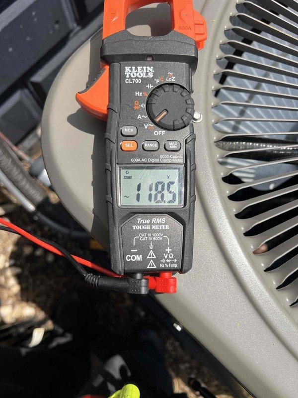 Completed comprehensive Gold AC inspection on a 1-year-old mini split system located in the basement. Performed electrical diagnostics using digital clamp meter, recording voltage readings of 118.5V and 1102 (amperage or secondary measurement) to verify proper system operation and electrical performance. All components inspected and confirmed to be functioning within normal parameters, with unit operating as designed at time of service.
