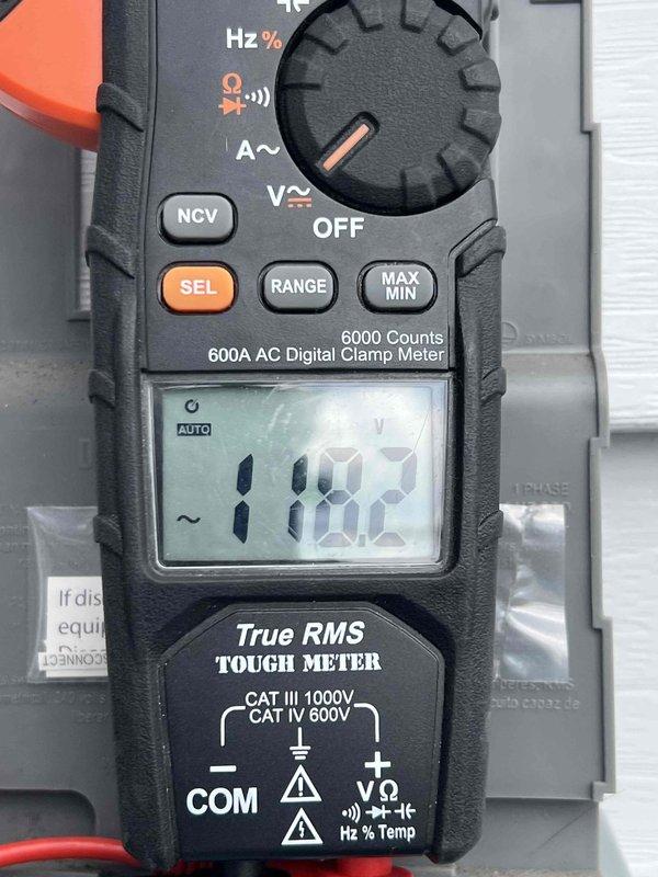 Completed comprehensive Gold AC inspection on a 1-year-old mini split system located in the basement. Performed electrical diagnostics using digital clamp meter, recording voltage readings of 118.5V and 1102 (amperage or secondary measurement) to verify proper system operation and electrical performance. All components inspected and confirmed to be functioning within normal parameters, with unit operating as designed at time of service.