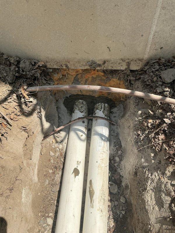 Installed new refrigerant line-sets through underground PVC conduit previously installed by plumbing contractor, running from foundation penetration point through excavated trench in yard. Evacuated and charged system with refrigerant to manufacturer specifications, ensuring proper operation of HVAC equipment.