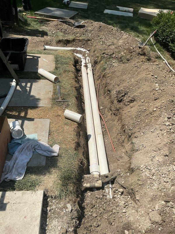 Installed new refrigerant line-sets through underground PVC conduit previously installed by plumbing contractor, running from foundation penetration point through excavated trench in yard. Evacuated and charged system with refrigerant to manufacturer specifications, ensuring proper operation of HVAC equipment.