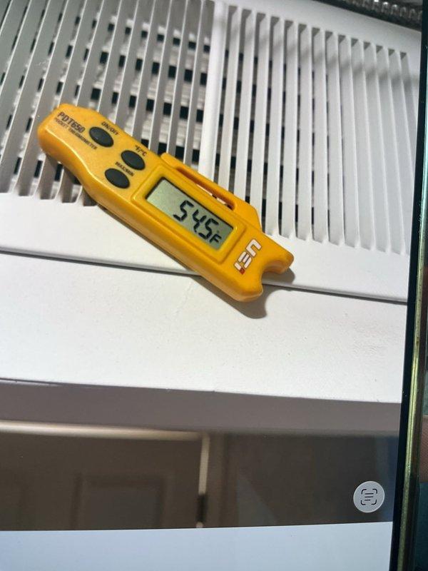 Responded to no cooling complaint on 6-year-old AC unit located in basement. Upon inspection, found failed dual run capacitor preventing compressor operation. Replaced defective capacitor with new unit rated at 5mfd, reconnected all wire terminations, and verified proper system operation. Measured supply air temperature at 54.5°F, confirming restored cooling capacity and normal system function.