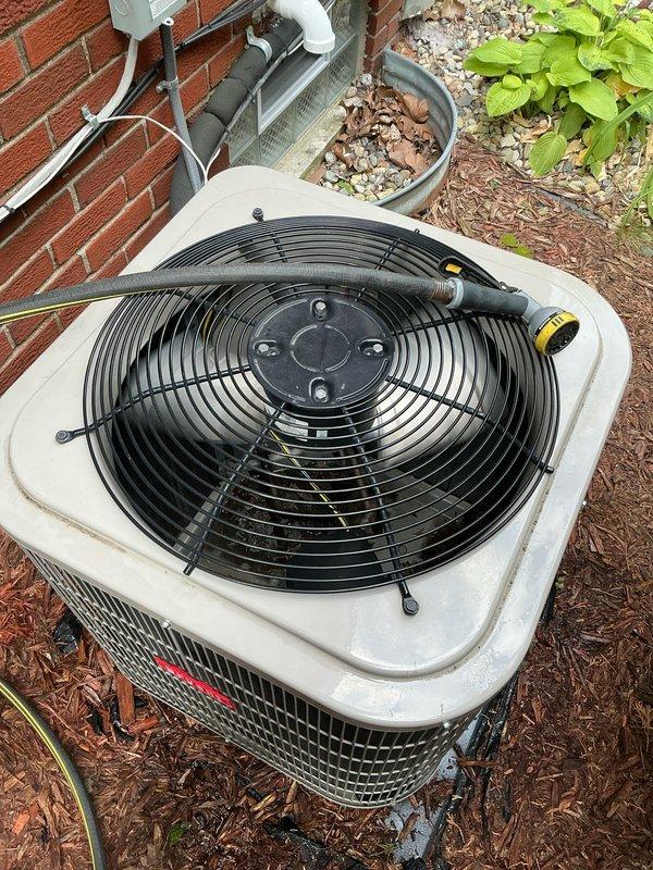 Completed comprehensive NSP AC inspection on 3-year-old residential air conditioning system located in basement. Verified unit operational status with homeowner present. Inspected indoor air handler assembly including Honeywell Home FC100A1029 air filter unit (16x25x4, MERV 11 rating) installed in metal ductwork system. Examined control panel display and verified proper function. Assessed outdoor condenser unit positioned on exterior mulch bed adjacent to brick structure. Inspected condenser fan operation, protective grille, and exterior casing condition. Checked electrical conduit and wiring connections at exterior installation. System operating within normal parameters with no deficiencies noted at time of inspection.