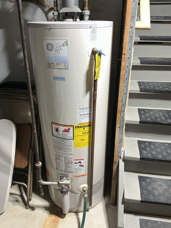 Completed comprehensive Gold AC and generator inspection on 5-year-old Briggs & Stratton 13KW standby generator and air conditioning system with air handler located in basement. All equipment confirmed operational at time of inspection. Performed multi-point inspection protocol including visual examination of generator components, electrical connections, fuel system, and transfer switch operation. Conducted thorough AC system evaluation including refrigerant levels, electrical components, condensate drainage, and air handler operation. Documented existing conditions with photographic evidence showing basement mechanical equipment including water heater installation dated 2008 and PVC condensate drainage system. Noted brown discoloration present on curved section of condensate drain piping, indicating potential biological growth or iron bacteria accumulation that may require future attention to prevent drainage issues. All primary HVAC and generator systems functioning within normal par