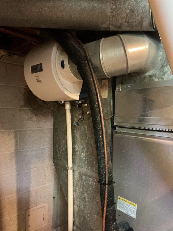 Responded to furnace water leak in basement following power outage. Upon inspection, found humidifier solenoid valve failing to close properly, allowing continuous water flow into the humidifier pad and overflow into the furnace cabinet. Replaced faulty solenoid valve and verified proper operation through multiple test cycles. Inspected furnace interior for water damage, checked electrical connections for moisture exposure, and confirmed all components functioning correctly. System restored to normal operation with no further leakage detected.
