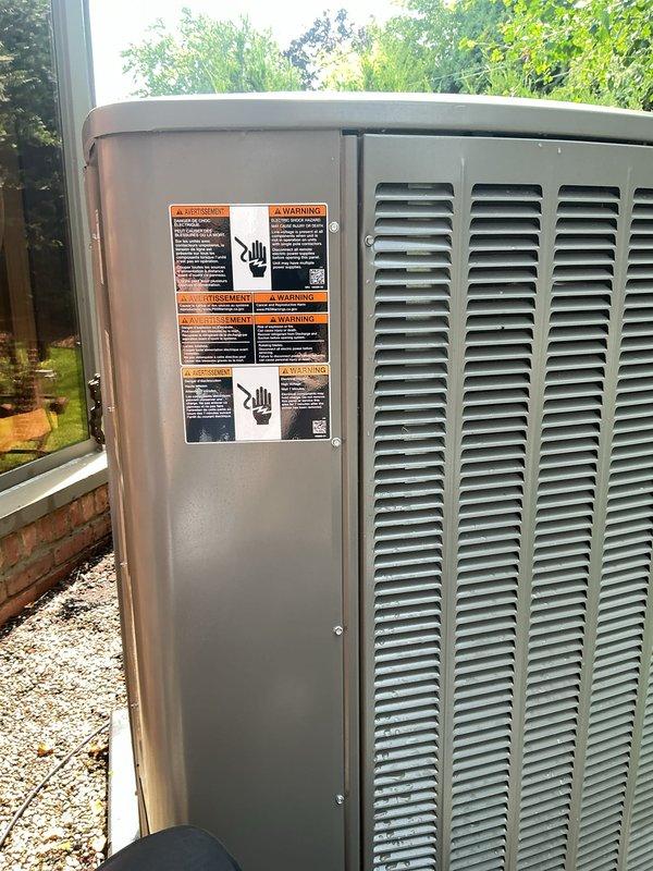 Completed comprehensive Gold AC inspection on a 2-year-old single-unit HVAC system with outdoor condenser and basement air handler. System was operational at time of service. Performed thorough visual inspection of outdoor condenser unit, confirming equipment is in excellent condition with no visible signs of damage, rust, or deterioration. All safety labels and warning decals remain intact and legible. Unit casing and components show proper maintenance with clean exterior surfaces. Verified proper installation on gravel pad with adequate clearance and airflow. Equipment operating normally with no immediate service concerns identified.