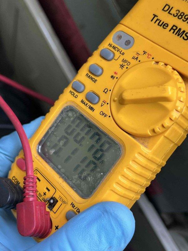 Responded to service call for central air conditioning system with reduced cooling capacity. Upon arrival, located Bryant brand condenser unit positioned against building exterior with overgrown vegetation restricting airflow around unit. Cleared debris and plant material from base and sides of condenser to restore proper ventilation and prevent efficiency loss. Performed electrical diagnostics using digital multimeter to verify system voltage, amperage draw, and component functionality. All electrical readings confirmed within manufacturer specifications with no detected abnormalities. Conducted thorough leak check of refrigerant system including condenser coil, service ports, and line connections - no leaks detected. System operating properly with adequate cooling output restored following vegetation clearance and diagnostic verification.