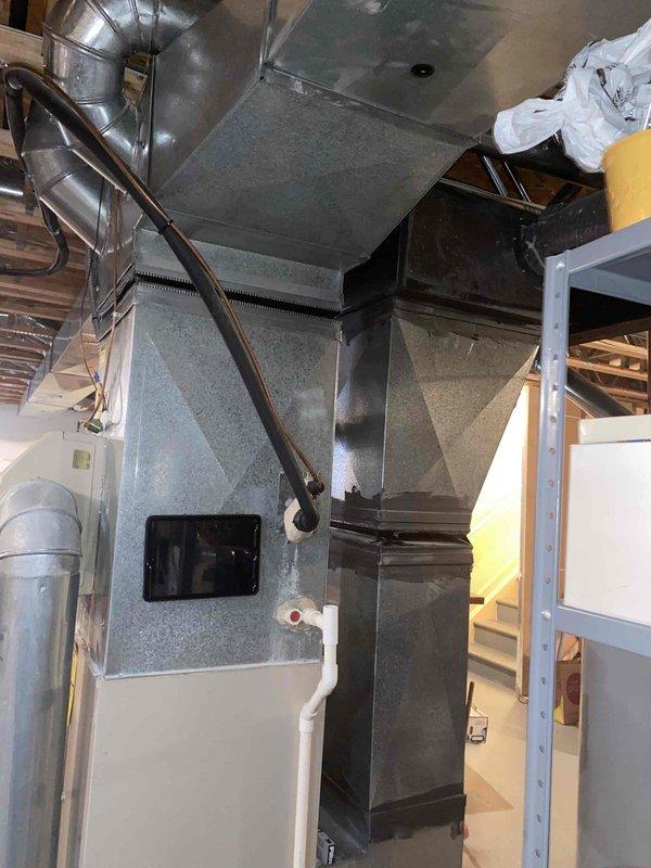 Conducted comprehensive evaluation of 23-year-old residential HVAC system including indoor air handler with ductwork distribution network and outdoor condensing unit. Documented existing equipment condition showing significant age-related wear, dust accumulation on furnace cabinet and plenum assembly, and assessed all refrigerant line connections, electrical disconnects, and system components for replacement recommendation. Provided full system replacement estimate based on current equipment age exceeding typical service life expectancy.