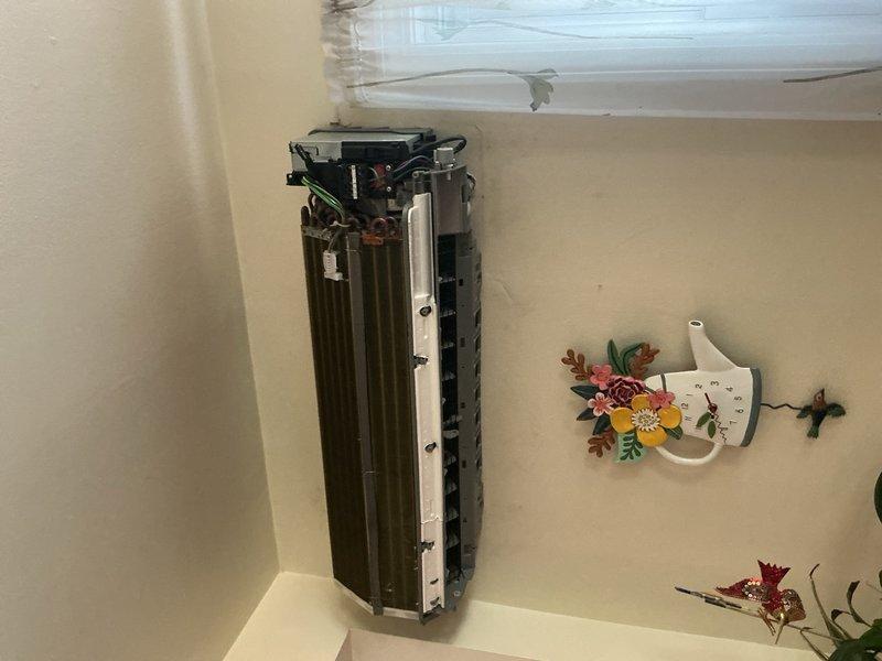 Performed comprehensive leak search on mini-split air conditioning system with wall-mounted evaporator coil assembly. Identified failed evaporator coil requiring replacement, which has been ordered under purchase order 1350720-001 with expected arrival in 7 business days. Documented system condition with photographs of indoor air handler unit and outdoor condenser unit for warranty processing and future reference.