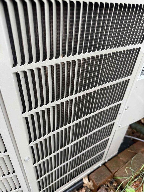 Completed comprehensive Gold AC Inspection on 13-year-old Bryant HVAC system with basement-located air handler and outdoor condensing unit. Performed multi-point inspection including visual assessment of indoor air handler cabinet, PVC vent piping integrity, and outdoor condenser unit with louvered side panels and heat exchanger coils. System confirmed operational at time of inspection with all major components functioning within normal parameters; documented equipment condition through photographic records showing both indoor and outdoor units in serviceable condition.