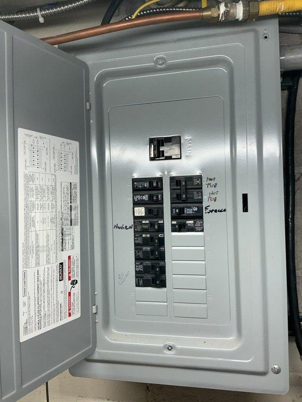 Completed site assessment and electrical estimate for new standby generator installation. Evaluated existing electrical infrastructure including main service panel and subpanel configuration to determine proper integration point for automatic transfer switch. Documented current electrical system layout, circuit loading, and available capacity to support generator interconnection. Photographed existing panel conditions showing circuit breaker arrangement, labeling, and available space for transfer switch wiring modifications required for generator hookup.