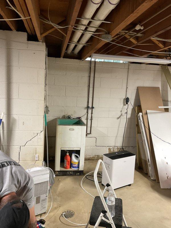 Completed full HVAC system installation in basement including 90,000 BTU high-efficiency furnace, 4-ton air conditioning unit with rear discharge configuration, humidifier, base pan, and condensate pump. Ran electrical conduit and reconnected existing electrical service. Installed new thermostat and verified all system controls and safety devices operating properly. Measured and documented AHRI certification number for utility rebate eligibility with both Consumers Energy and DTE programs. All equipment tested, commissioned, and left in proper working order with mechanical permit requested for inspection.