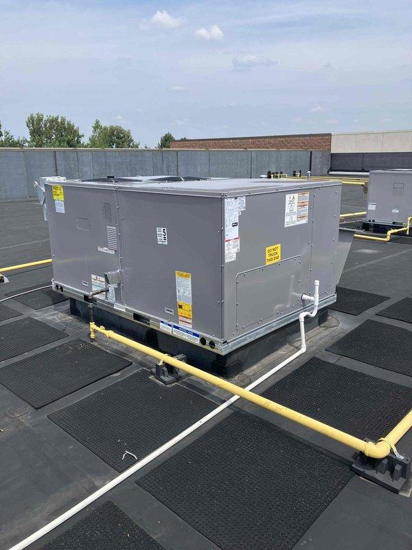 Completed like-for-like replacement of 7.5 ton Carrier rooftop unit on commercial building using 28-ton crane for equipment delivery, positioning, and haul-away of existing unit. Installed new RTU on weatherstripped curb adapter with rubber isolation pads, updated gas valve, replaced thermostat with White-Rodgers 1F95-0680 model, installed economizer for energy efficiency, utilized existing electrical disconnect, and performed complete system startup including heat exchanger burn-off and operational verification.